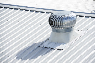Stainless steel exhaust fan on factory roof.